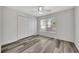 Bedroom with a large window, ceiling fan, and double closet, providing plenty of natural light and storage at 3870 Island Way, St Petersburg, FL 33705