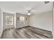 Spacious bedroom with gray flooring, two windows, ceiling fan, and natural light at 3870 Island Way, St Petersburg, FL 33705
