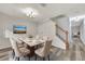 Dining room with gray flooring, a staircase, and a table set for six at 3870 Island Way, St Petersburg, FL 33705
