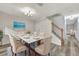 Bright dining room features a table set for six and gray wood flooring at 3870 Island Way, St Petersburg, FL 33705