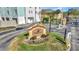 An eye-level view of the Coquina Key Townhomes entrance sign surrounded by immaculate landscaping in a gated community at 3870 Island Way, St Petersburg, FL 33705