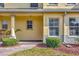 Close-up of townhouse exterior featuring a covered entryway and decorative stone accents at 3870 Island Way, St Petersburg, FL 33705