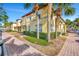 Charming townhouse complex featuring lush landscaping, brick sidewalks, and beautiful palm trees at 3870 Island Way, St Petersburg, FL 33705