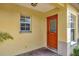 Warm and inviting entrance to the townhouse with an orange front door at 3870 Island Way, St Petersburg, FL 33705