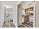 Bright kitchen featuring modern wood-look flooring, white appliances, and natural light at 3870 Island Way, St Petersburg, FL 33705