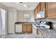 Functional kitchen with granite countertops, modern flooring, and white appliances at 3870 Island Way, St Petersburg, FL 33705