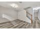 Bright living room features modern gray flooring and a staircase with a classic wood railing at 3870 Island Way, St Petersburg, FL 33705