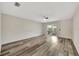 Spacious living room featuring modern wood-look flooring and a sliding glass door at 3870 Island Way, St Petersburg, FL 33705