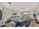Bright living room features a large gray couch, two gray armchairs, and a sliding door to the outside at 3870 Island Way, St Petersburg, FL 33705
