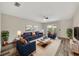Comfortable living room boasts a plush blue sofa, matching chairs, and stylish decor at 3870 Island Way, St Petersburg, FL 33705