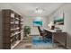 Contemporary staged office with a modern desk, bookcase, and vibrant artwork for inspiration at 3870 Island Way, St Petersburg, FL 33705