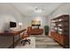 Nicely staged home office with a wooden desk, orange chair, and storage shelves, ready for work at 3870 Island Way, St Petersburg, FL 33705