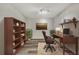 Elegant staged office with dark wood furniture, a bookcase, and traditional decor for a refined workspace at 3870 Island Way, St Petersburg, FL 33705