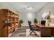 Stylishly staged office with a dark wood desk, executive chair, and bookcase, perfect for productivity at 3870 Island Way, St Petersburg, FL 33705