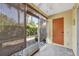 Enclosed patio with bamboo shades and outdoor views, leading to a door at 3870 Island Way, St Petersburg, FL 33705