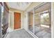 Enclosed patio with a concrete floor, door, and sliding glass doors offering a seamless transition to outdoor living at 3870 Island Way, St Petersburg, FL 33705
