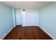 This bedroom features hardwood floors, white trim and doors, and light blue walls at 400 Island Way # 911, Clearwater Beach, FL 33767