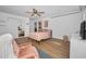 Cozy bedroom featuring laminate floors, a ceiling fan, and a comfortable seating area at 4191 39Th S St, St Petersburg, FL 33711