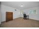 Bedroom with carpet flooring, two windows, and a dark-stained dresser at 4191 39Th S St, St Petersburg, FL 33711