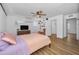 Light and bright bedroom with a ceiling fan, laminate flooring, and a view to the hallway at 4191 39Th S St, St Petersburg, FL 33711