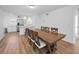 Dining room with a rustic wooden table set, modern pendant lights, and a view of the kitchen at 4191 39Th S St, St Petersburg, FL 33711