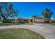 Inviting home with a wide driveway and lush front lawn, complemented by mature trees and landscaping at 4191 39Th S St, St Petersburg, FL 33711