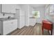 Efficient kitchen with white cabinetry, stone counters, and wood-look floors at 4191 39Th S St, St Petersburg, FL 33711