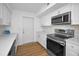 Modern kitchen features stainless steel appliances, white cabinets, and stylish backsplash tiles at 4191 39Th S St, St Petersburg, FL 33711