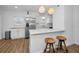 Bright kitchen with modern appliances, white cabinetry, quartz counters and bar seating at 4191 39Th S St, St Petersburg, FL 33711
