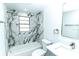 Bathroom featuring a tub/shower combo with marble-look tile and new brushed nickel hardware at 4222 Autumn Leaves Dr, Tampa, FL 33624