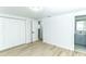 Bright bedroom with wood-look floors, closet and ensuite bathroom with updated vanity at 4222 Autumn Leaves Dr, Tampa, FL 33624