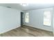 Light-filled bedroom with wood-look floors and two windows providing natural light at 4222 Autumn Leaves Dr, Tampa, FL 33624