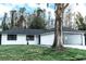 Well-maintained home exterior with a two car garage, tree, and manicured front lawn at 4222 Autumn Leaves Dr, Tampa, FL 33624
