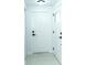 Bright hallway featuring white doors, updated hardware, and neutral tile flooring at 4222 Autumn Leaves Dr, Tampa, FL 33624