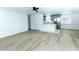 Open-concept living area with hardwood floors seamlessly flowing into a modern kitchen at 4222 Autumn Leaves Dr, Tampa, FL 33624