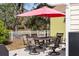 Outdoor patio featuring a table and chairs with red umbrella, perfect for entertaining or relaxing outdoors at 4407 Parnell Dr, Sarasota, FL 34232
