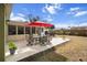 Backyard patio with outdoor dining, grill, and lush landscaping at 4407 Parnell Dr, Sarasota, FL 34232