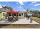 Backyard patio featuring outdoor dining, grill, and lush landscaping at 4407 Parnell Dr, Sarasota, FL 34232