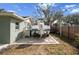 Backyard featuring a boat parked on a gravel lot with a wooden fence and a tree in the background at 4407 Parnell Dr, Sarasota, FL 34232
