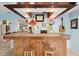 Stylized bar area featuring eclectic decor, warm lighting, and a guitar adding character to the entertainment space at 4407 Parnell Dr, Sarasota, FL 34232
