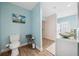 Well-lit bathroom with a modern vanity and a separate toilet area, accented by soft blue walls at 4407 Parnell Dr, Sarasota, FL 34232
