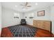Bright bedroom with hardwood floors, ceiling fan, dresser and chair at 4407 Parnell Dr, Sarasota, FL 34232