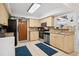 Well-lit kitchen featuring stainless steel appliances, tile flooring, and neutral cabinetry, with decor accents at 4407 Parnell Dr, Sarasota, FL 34232