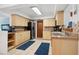 Bright kitchen with tile floors, featuring neutral cabinetry, stainless appliances, and view into another room at 4407 Parnell Dr, Sarasota, FL 34232