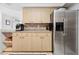 Well-organized kitchen showcasing neutral cabinets, stainless steel refrigerator, and adjacent dining/living area at 4407 Parnell Dr, Sarasota, FL 34232