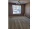 The carpeted bedroom has a ceiling fan and a large window for natural light at 5125 Palm Springs Blvd # 1101, Tampa, FL 33647