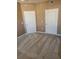 Carpeted bedroom features two white paneled doors for closet or ensuite access at 5125 Palm Springs Blvd # 1101, Tampa, FL 33647