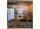Kitchen with a breakfast bar, tiled countertops, and light oak cabinets at 5125 Palm Springs Blvd # 1101, Tampa, FL 33647