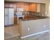Kitchen with tiled countertops, oak cabinets, and white appliances at 5125 Palm Springs Blvd # 1101, Tampa, FL 33647