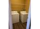 Laundry room with a full sized washer and dryer, and wire shelving at 5125 Palm Springs Blvd # 1101, Tampa, FL 33647